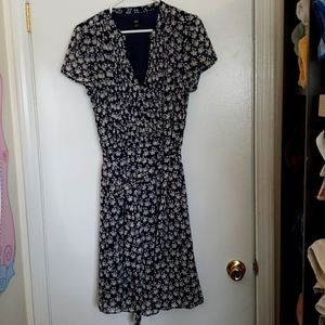 J.B.S. Navy blue floral dress with belt is sheer with a navy blue lining.